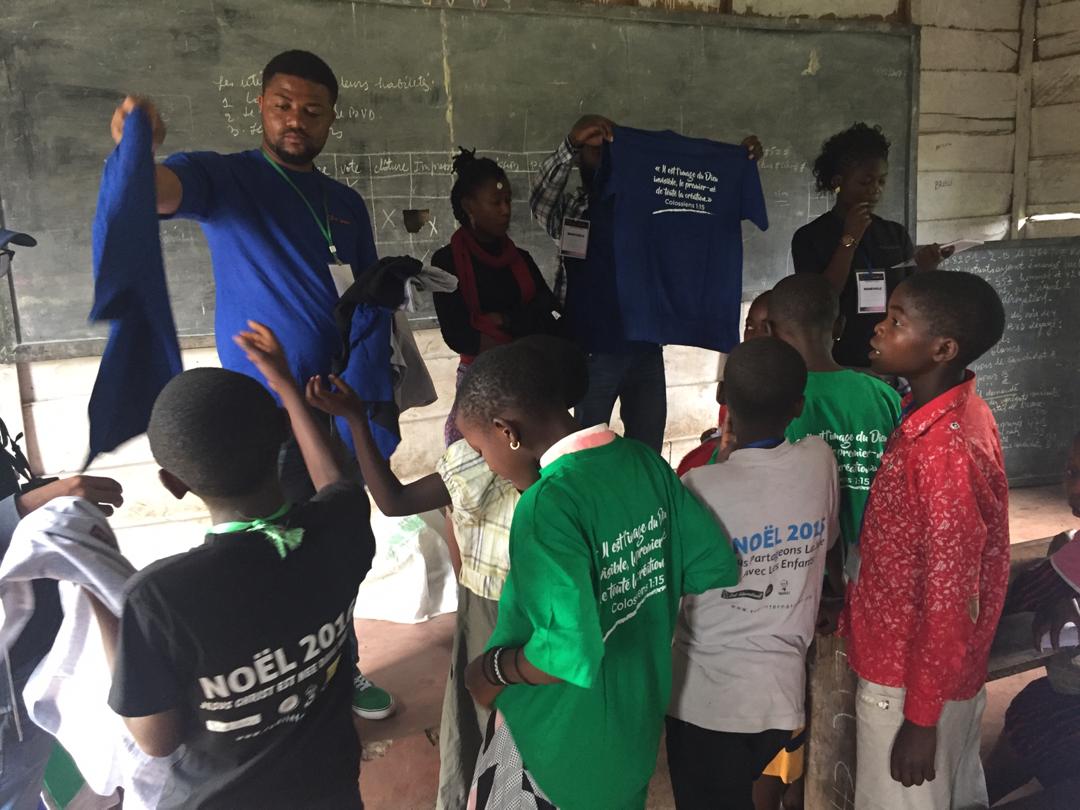 Image of Rudi International students receiving their new Christmas t-shirts.