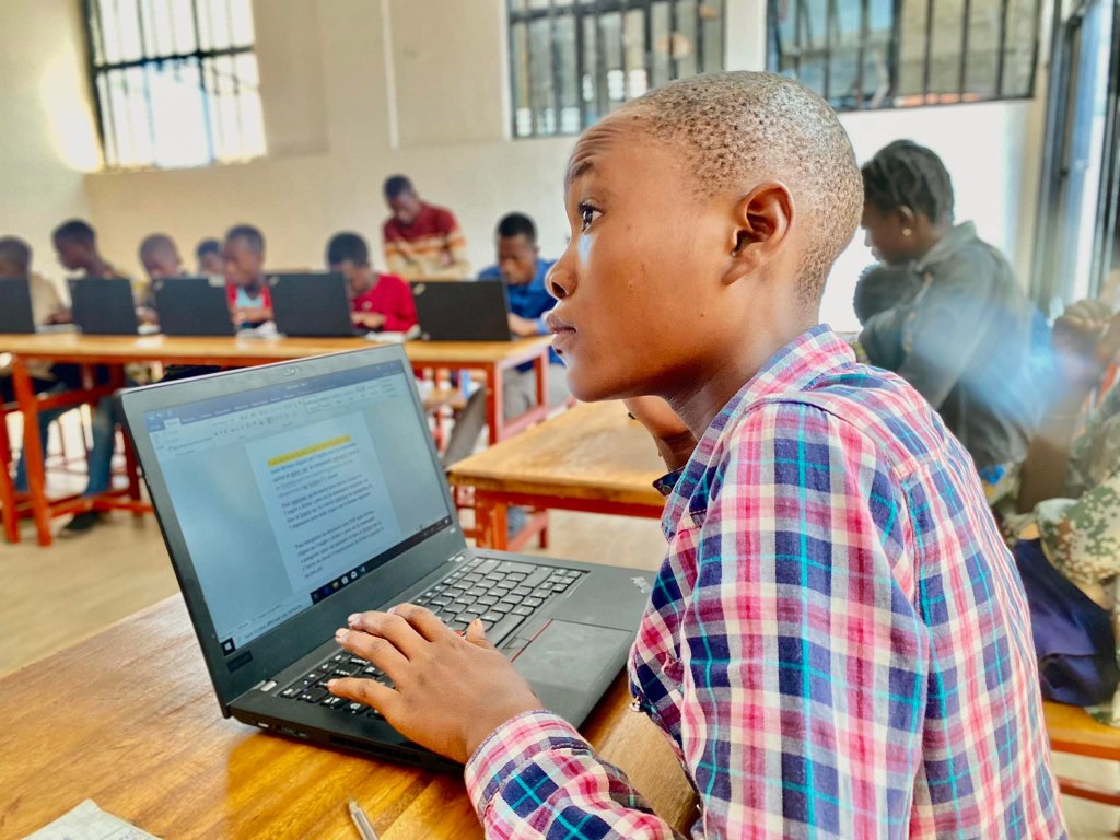 Picture of Students from the Rudi Education Program who are benefiting from computer literacy classes offered by Rudi International's Elimu Technology Center in Goma, DRC. These students will continue to take these classes as after-school activity even after the school year starts.